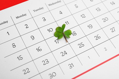 Photo of 17th March marked with fresh clover on calendar. St. Patrick's Day celebration