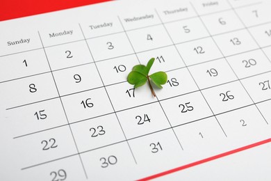 Photo of 17th March marked with fresh clover on calendar. St. Patrick's Day celebration