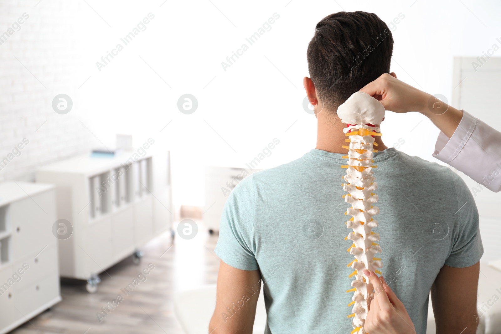 Photo of Man visiting orthopedist in medical office. Space for text