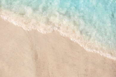 Photo of Sea waves rolling on beautiful sandy beach, above view. Summer vacation