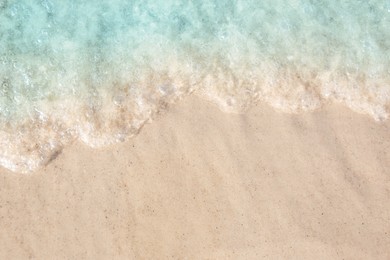 Photo of Sea waves rolling on beautiful sandy beach, top view. Summer vacation