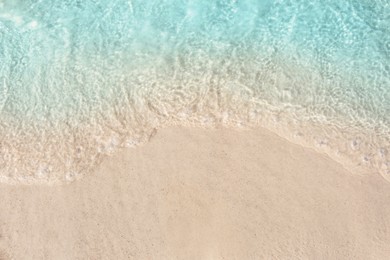 Photo of Sea waves rolling on beautiful sandy beach, top view. Summer vacation