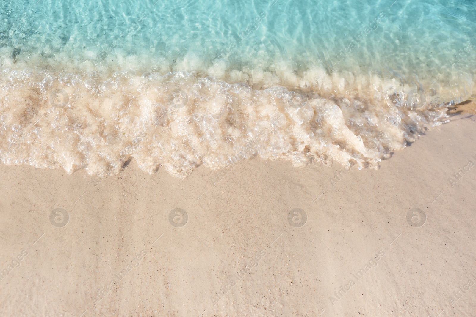 Photo of Sea waves rolling on beautiful sandy beach. Summer vacation