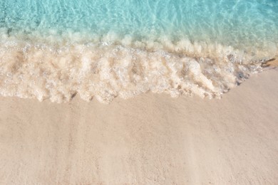 Photo of Sea waves rolling on beautiful sandy beach. Summer vacation