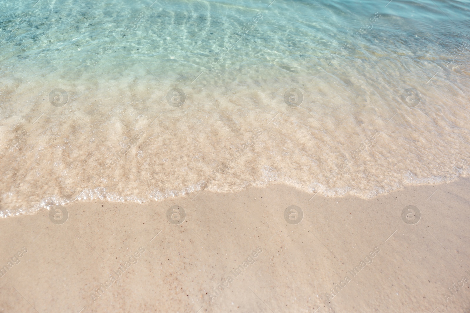 Photo of Sea waves rolling on beautiful sandy beach. Summer vacation