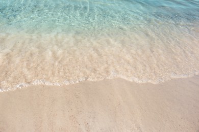 Photo of Sea waves rolling on beautiful sandy beach. Summer vacation