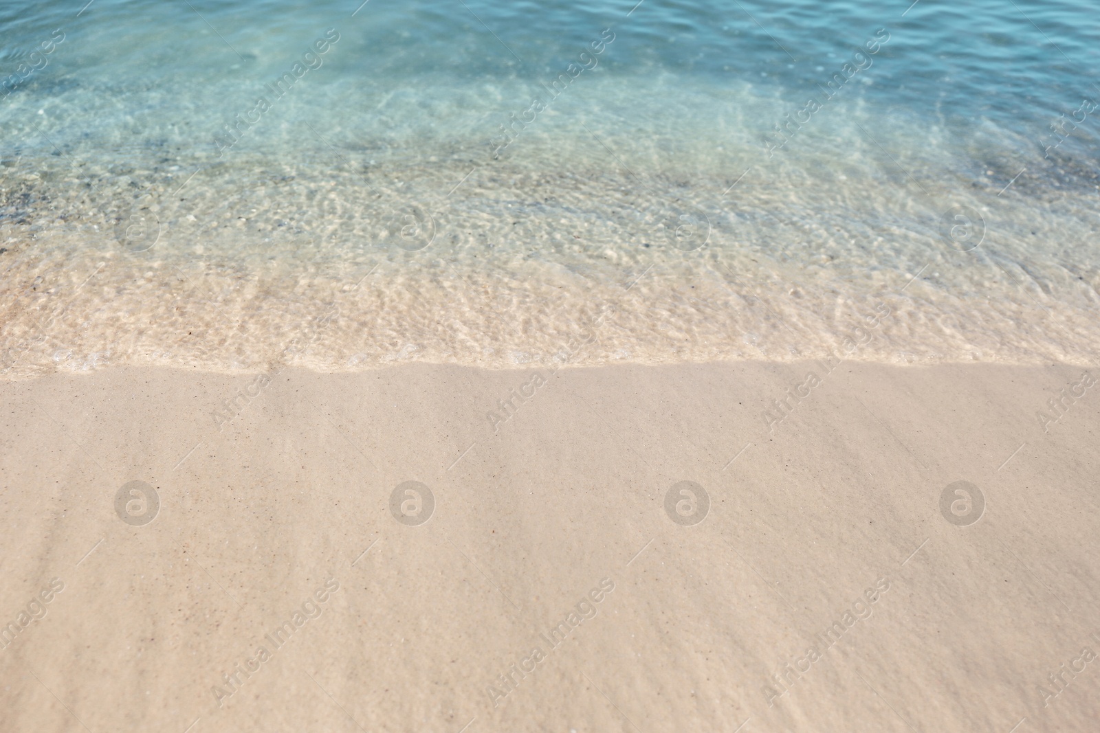 Photo of Sea waves rolling on beautiful sandy beach. Summer vacation