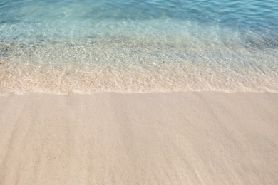 Photo of Sea waves rolling on beautiful sandy beach. Summer vacation