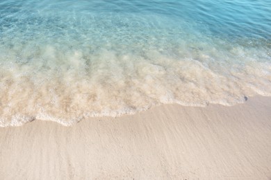 Photo of Sea waves rolling on beautiful sandy beach. Summer vacation