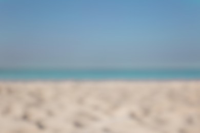 Photo of Blurred view of beautiful sandy beach and sea on sunny day. Summer vacation