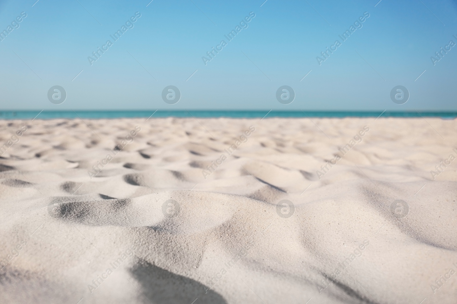 Photo of Beautiful sandy beach and sea on sunny day. Summer vacation