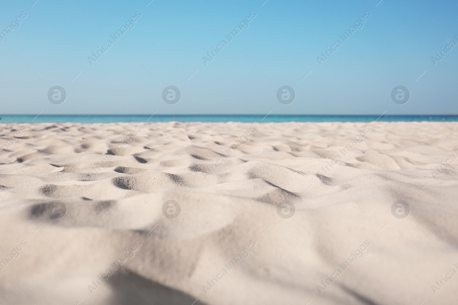 Photo of Beautiful sandy beach and sea on sunny day. Summer vacation