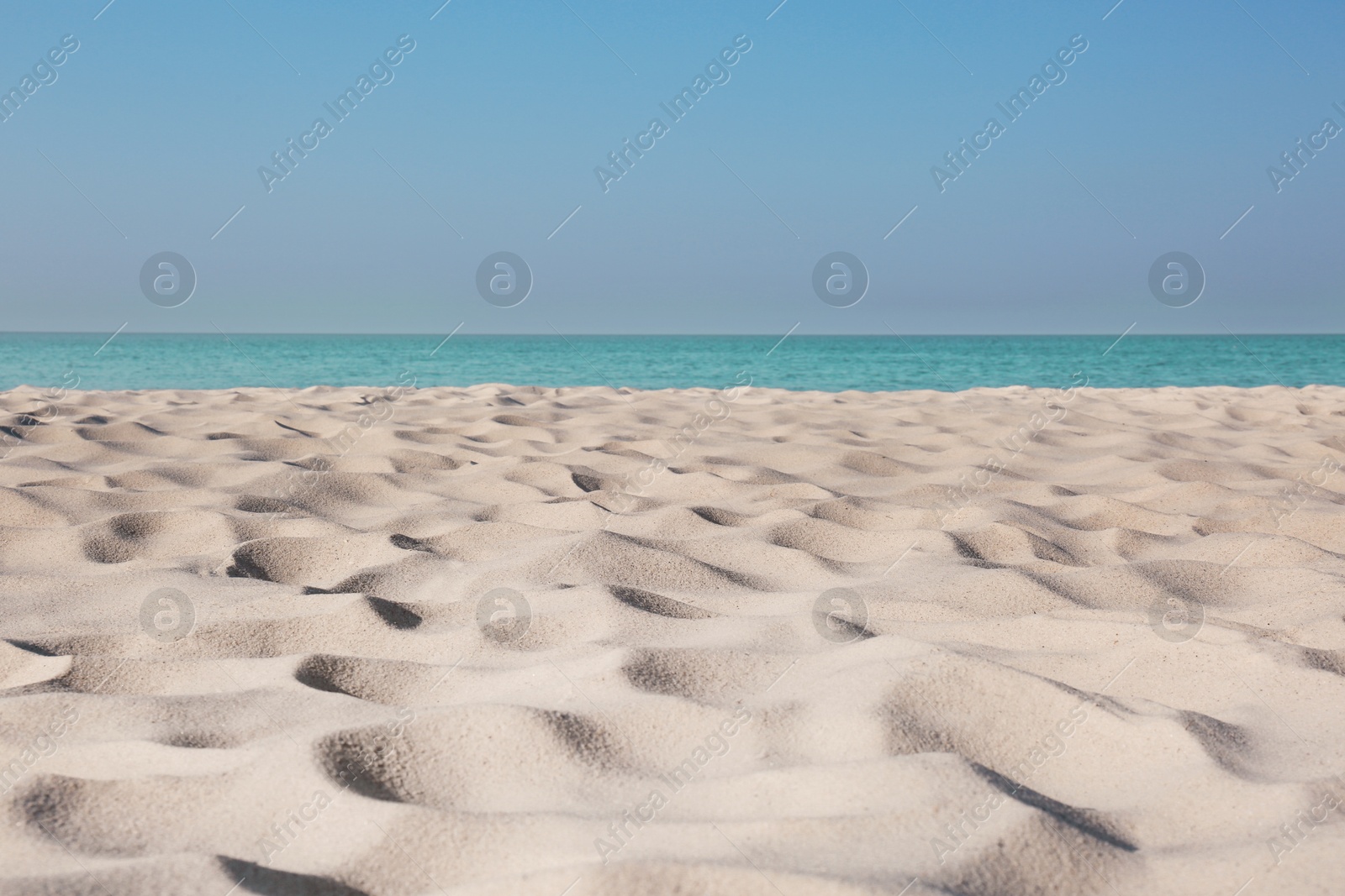 Photo of Beautiful sandy beach and sea on sunny day. Summer vacation