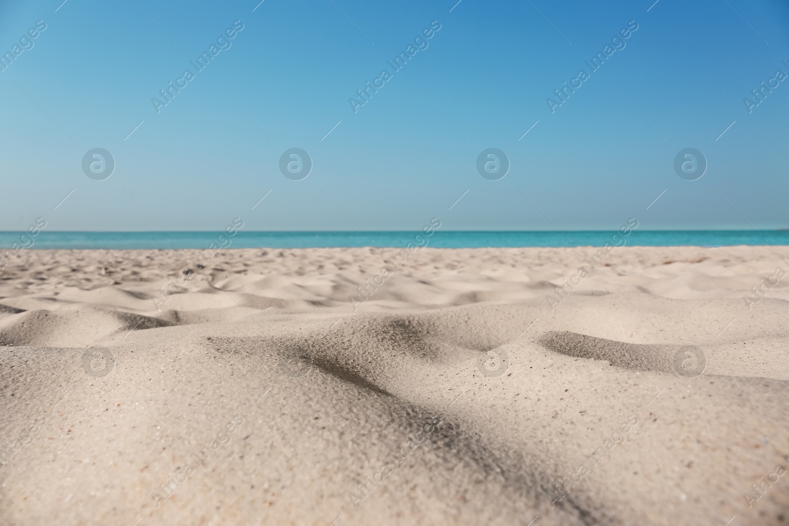 Photo of Beautiful sandy beach and sea on sunny day. Summer vacation