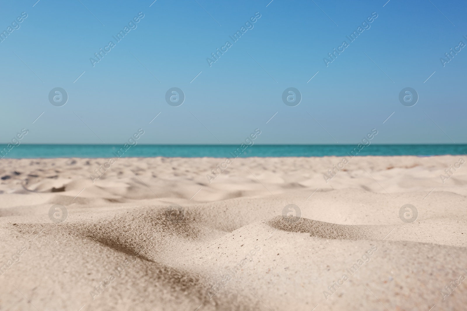 Photo of Beautiful sandy beach and sea on sunny day. Summer vacation