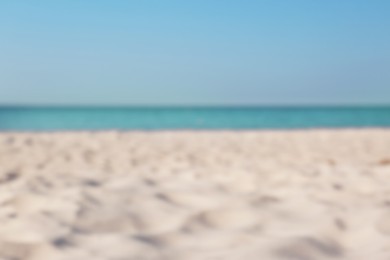 Photo of Blurred view of beautiful sandy beach and sea on sunny day. Summer vacation