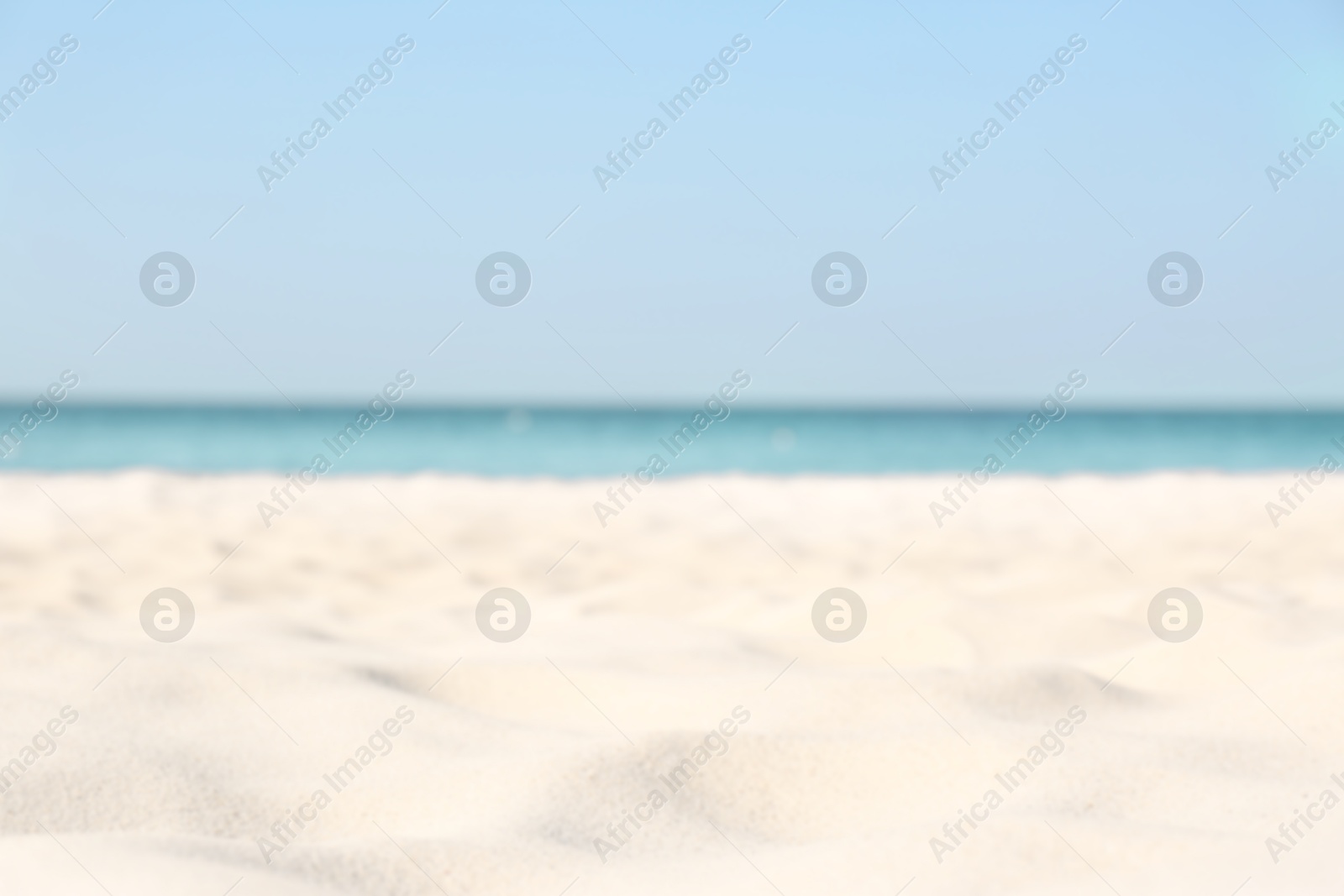 Photo of Blurred view of beautiful sandy beach and sea on sunny day. Summer vacation