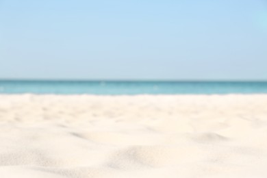 Photo of Blurred view of beautiful sandy beach and sea on sunny day. Summer vacation