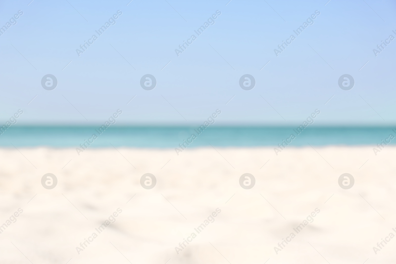 Photo of Blurred view of beautiful sandy beach and sea on sunny day. Summer vacation