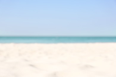 Photo of Blurred view of beautiful sandy beach and sea on sunny day. Summer vacation