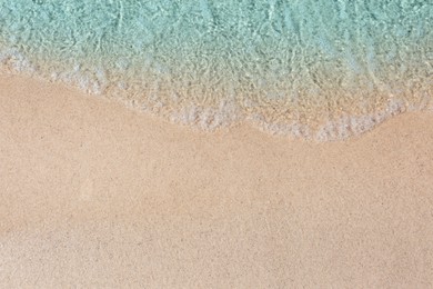 Photo of Sea waves rolling on beautiful sandy beach, top view. Summer vacation