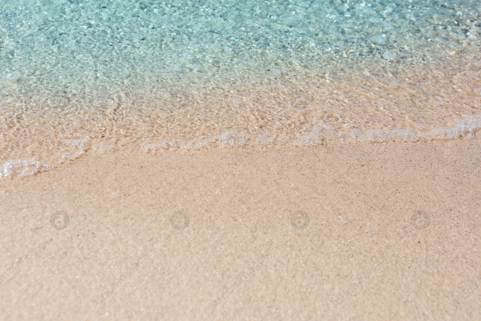 Photo of Sea waves rolling on beautiful sandy beach. Summer vacation