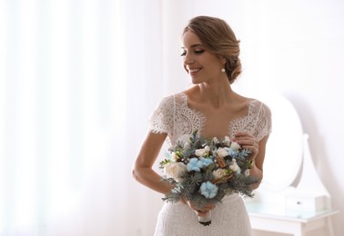 Beautiful bride with winter wedding bouquet indoors. Space for text