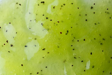 Photo of Texture of yellow shower gel as background, closeup