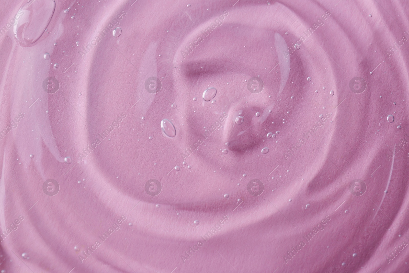 Photo of Sample of transparent shower gel on pink background, closeup