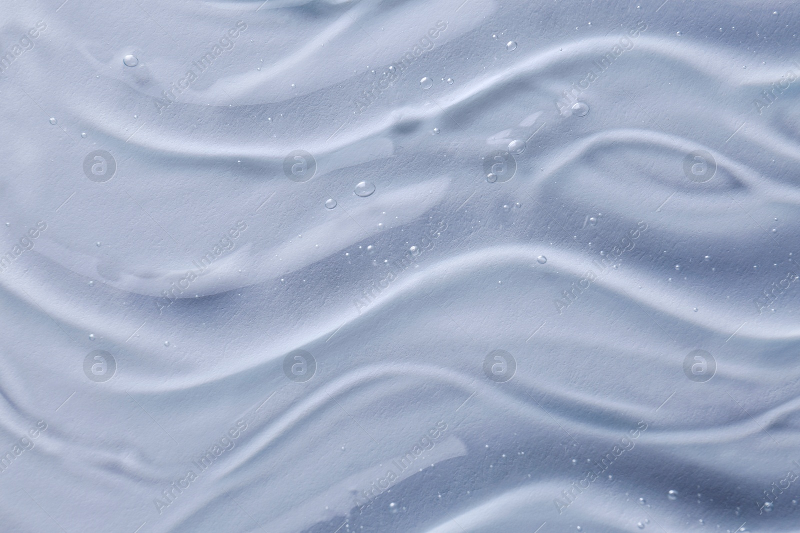 Photo of Texture of transparent shower gel on white background, closeup