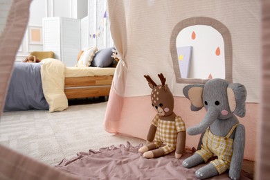 Cute toy reindeer and elephant in teepee tent for kids. Interior design