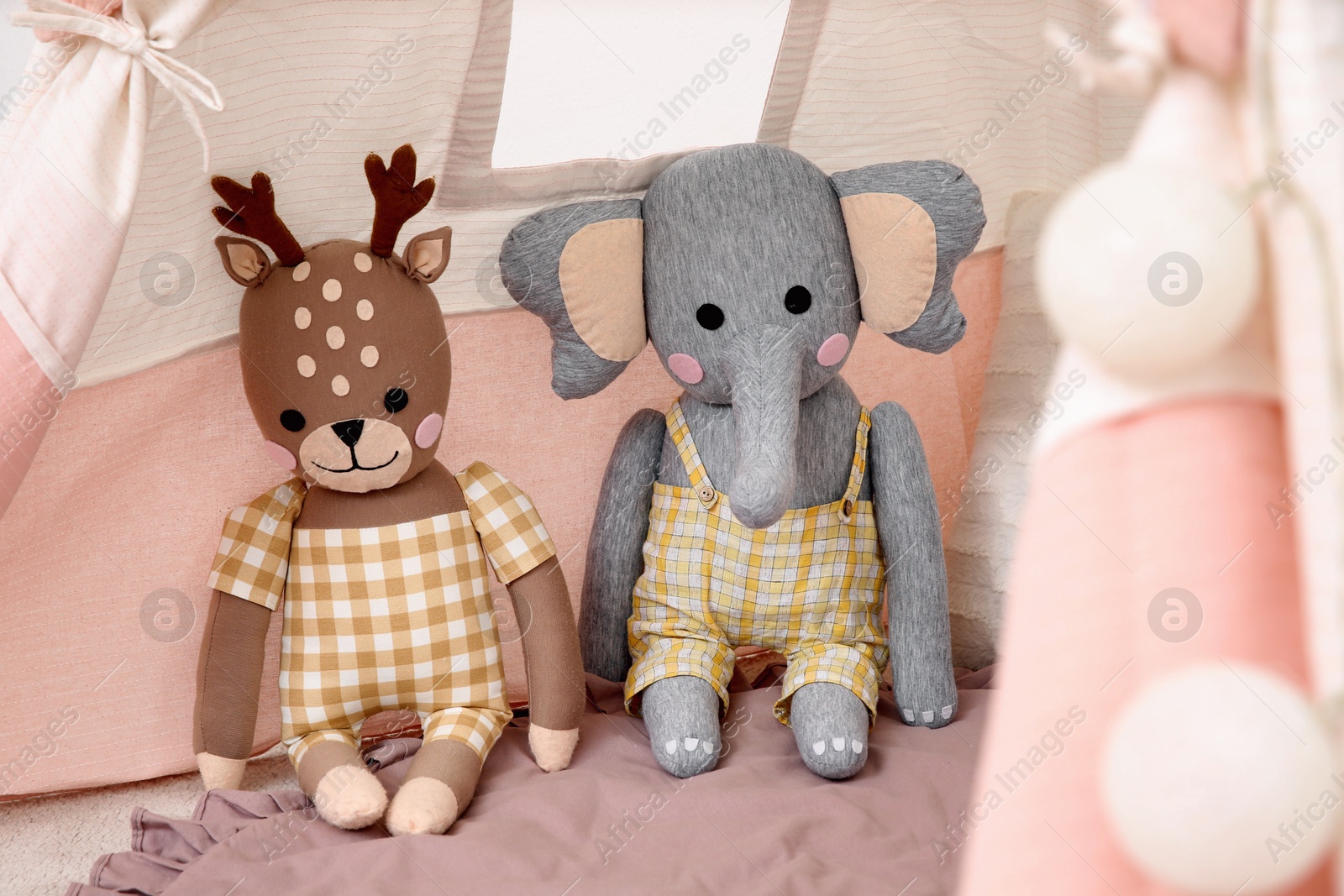 Photo of Cute toy reindeer and elephant in teepee tent for kids.