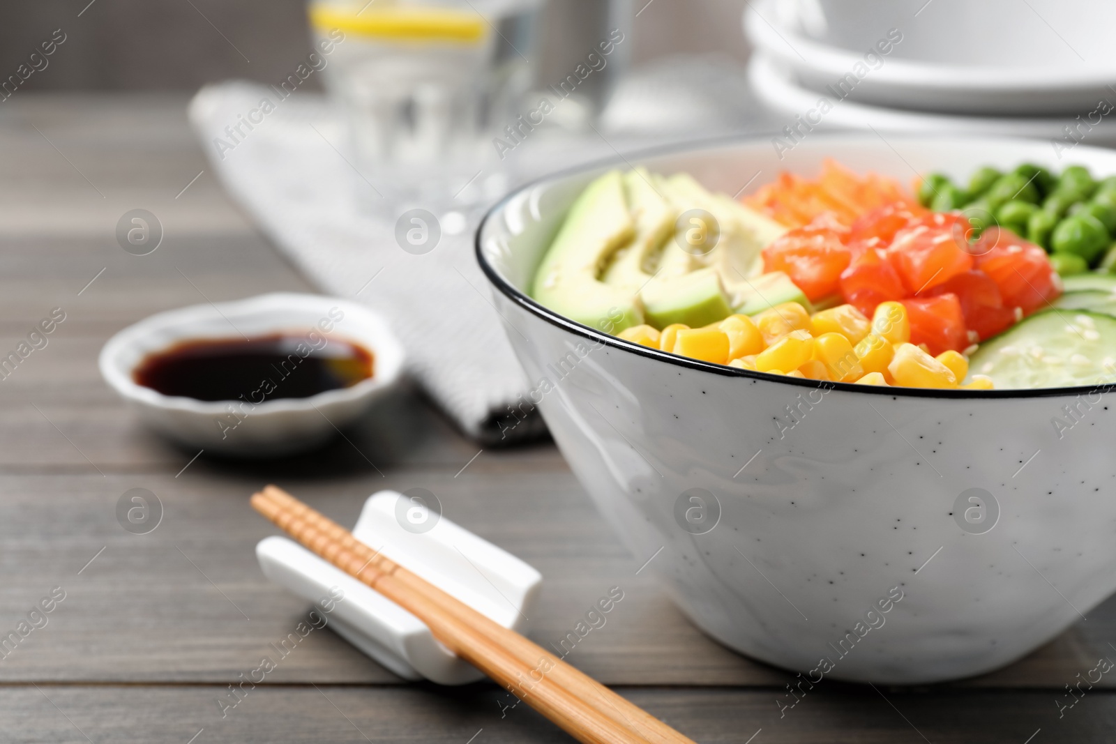 Photo of Delicious salad with salmon and vegetables on wooden table, closeup. Space for text