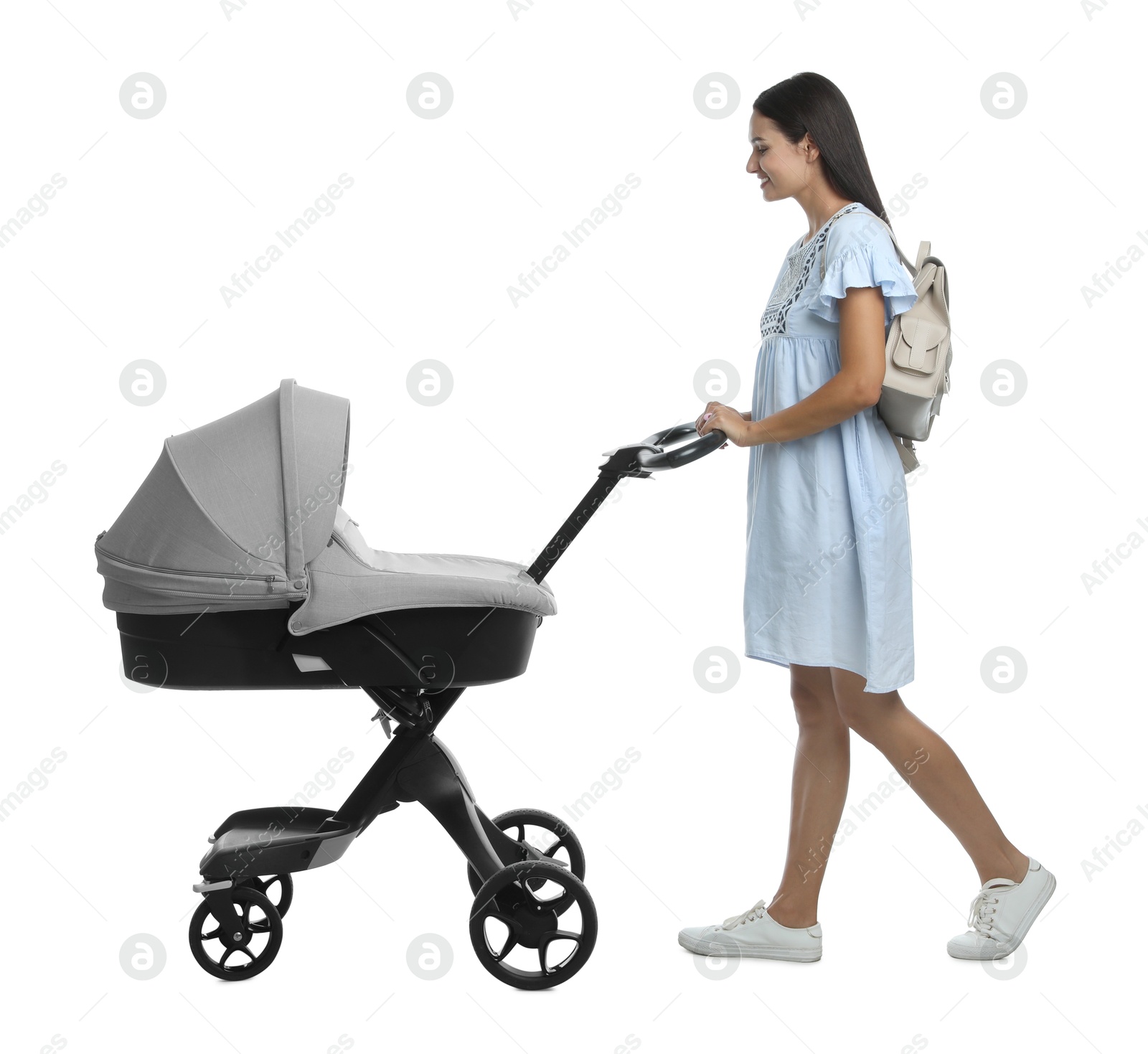 Photo of Happy young woman with baby stroller on white background