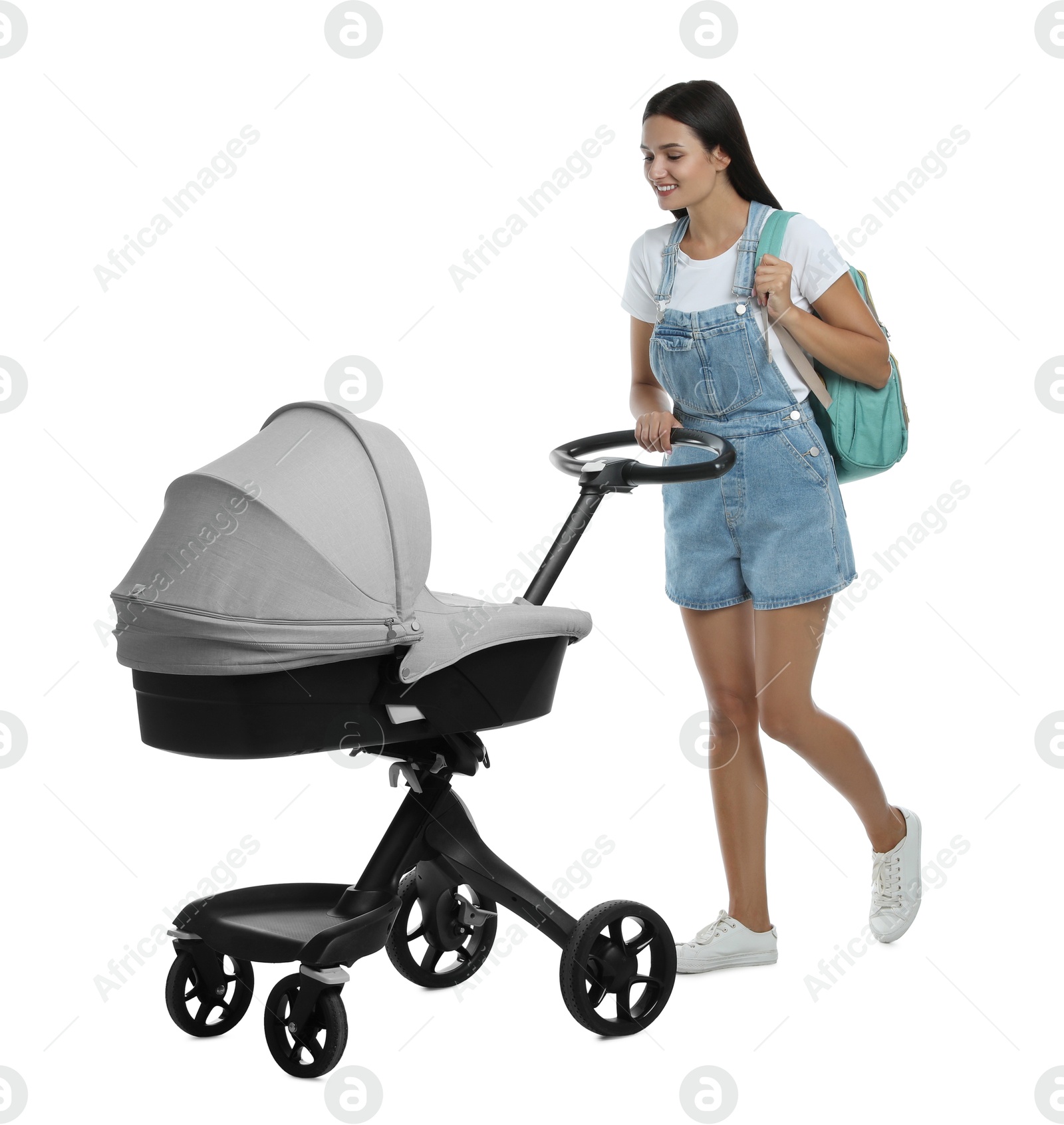 Photo of Happy young woman with baby stroller on white background