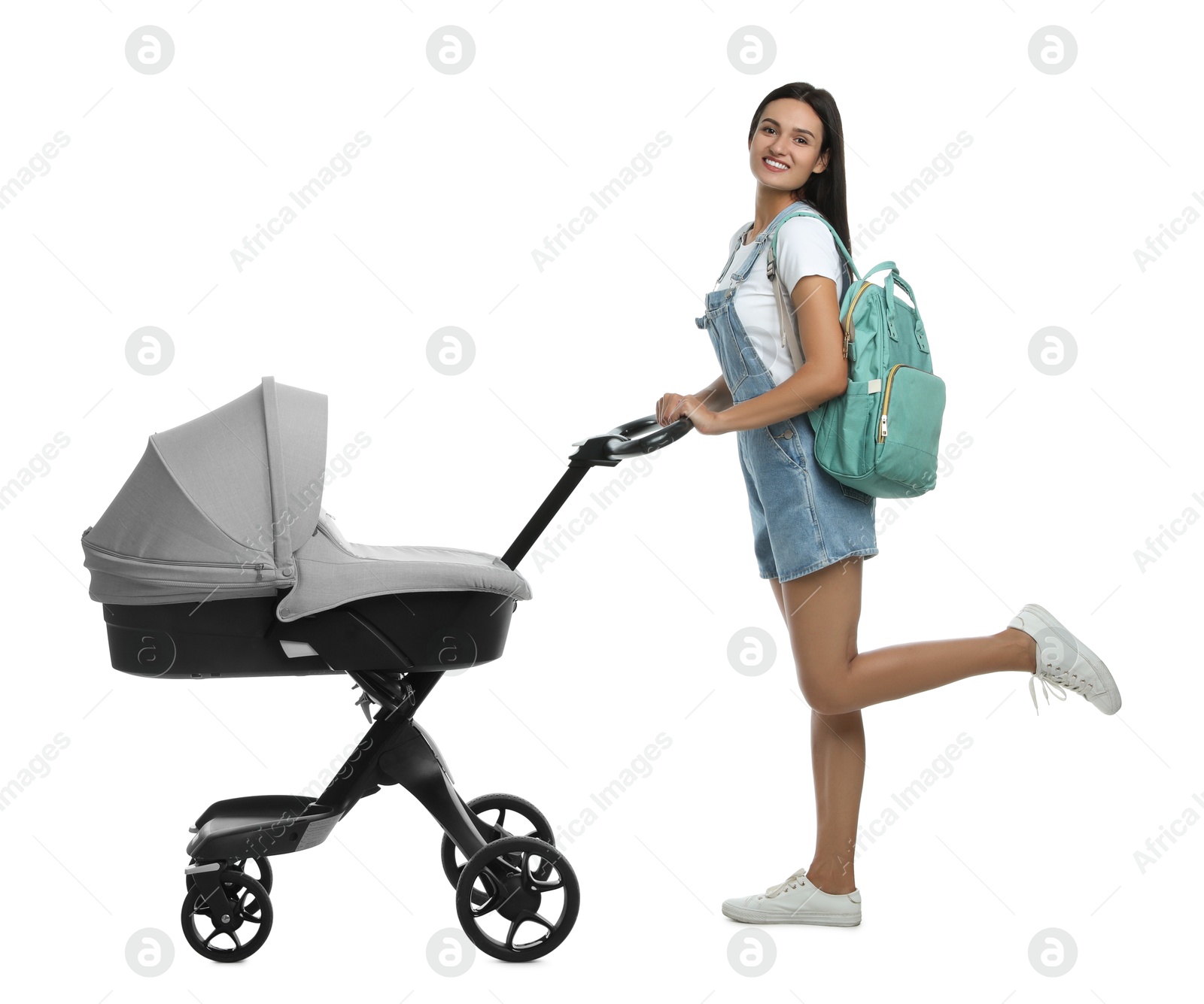 Photo of Happy young woman with baby stroller on white background