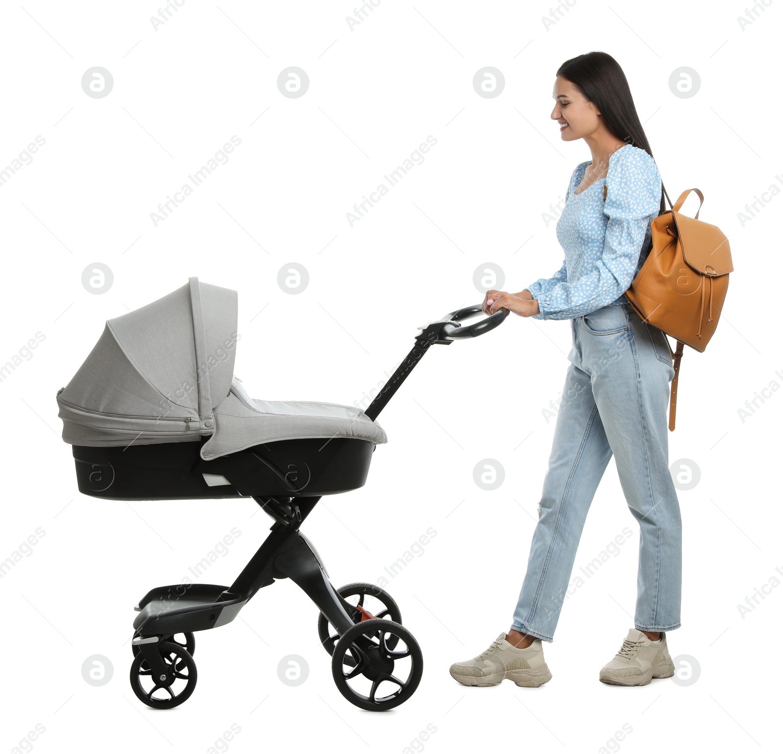 Photo of Happy young woman with baby stroller on white background