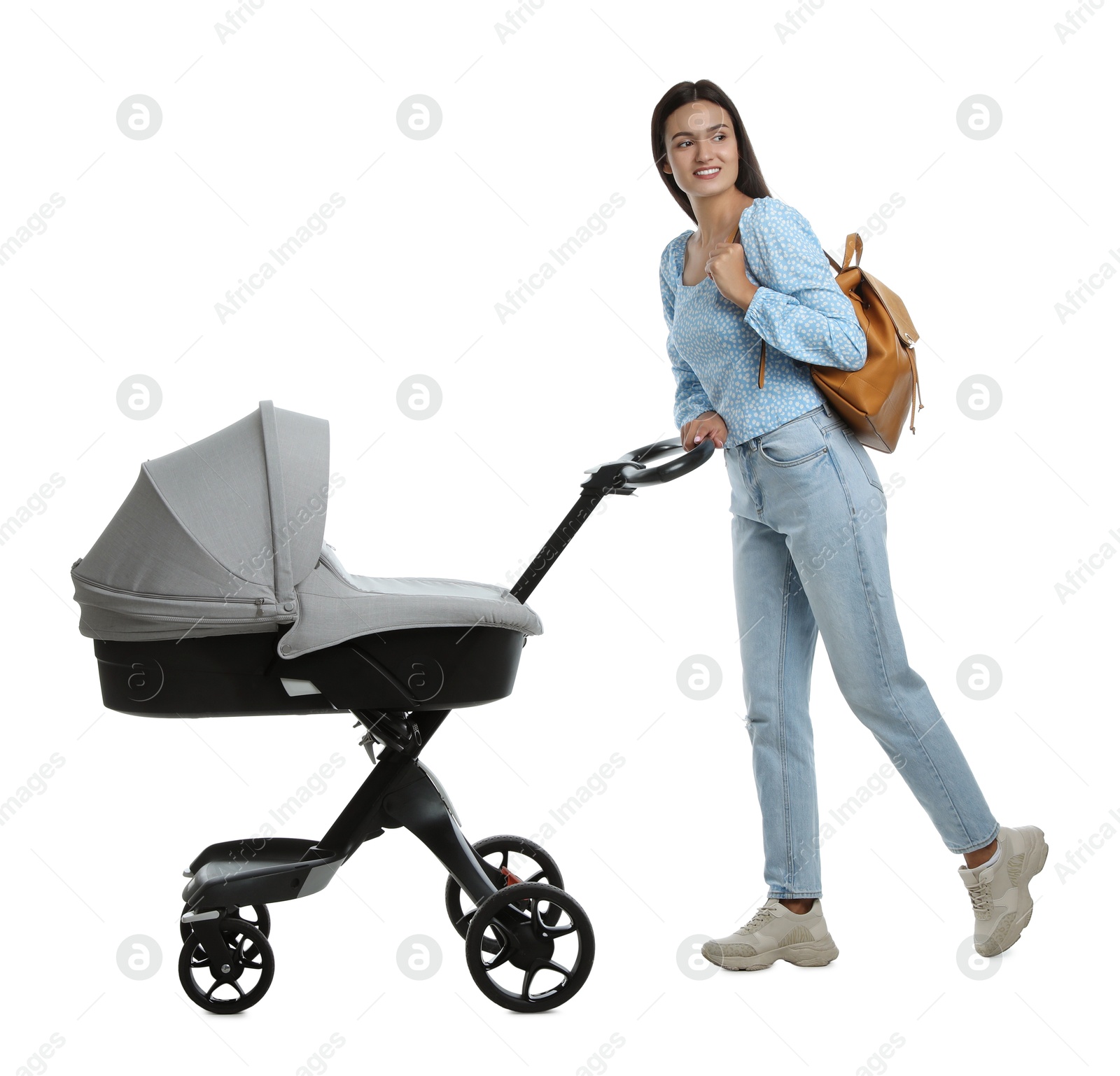 Photo of Happy young woman with baby stroller on white background