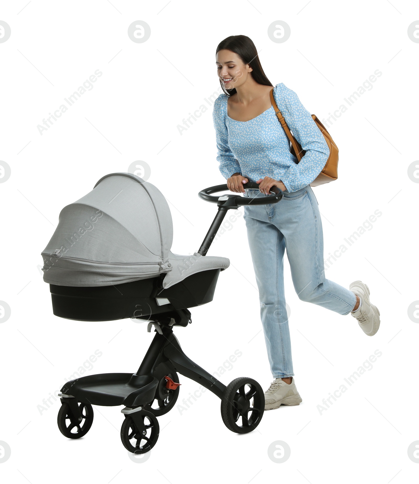 Photo of Happy young woman with baby stroller on white background