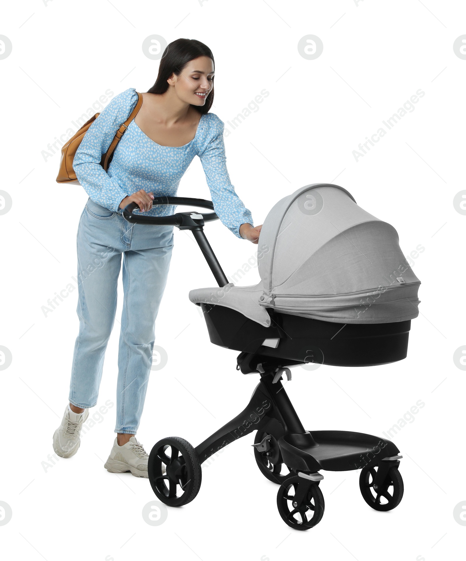 Photo of Happy young woman with baby stroller on white background