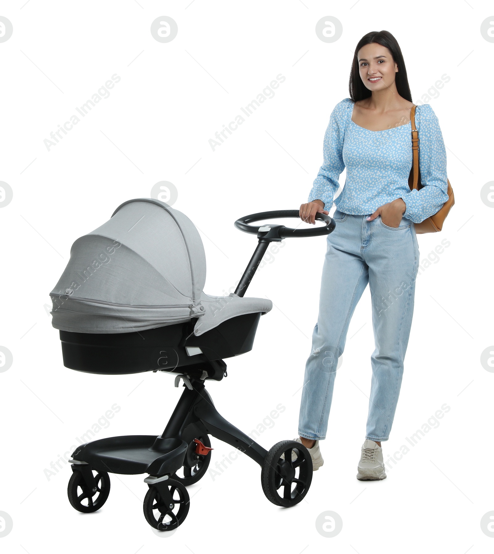 Photo of Happy young woman with baby stroller on white background