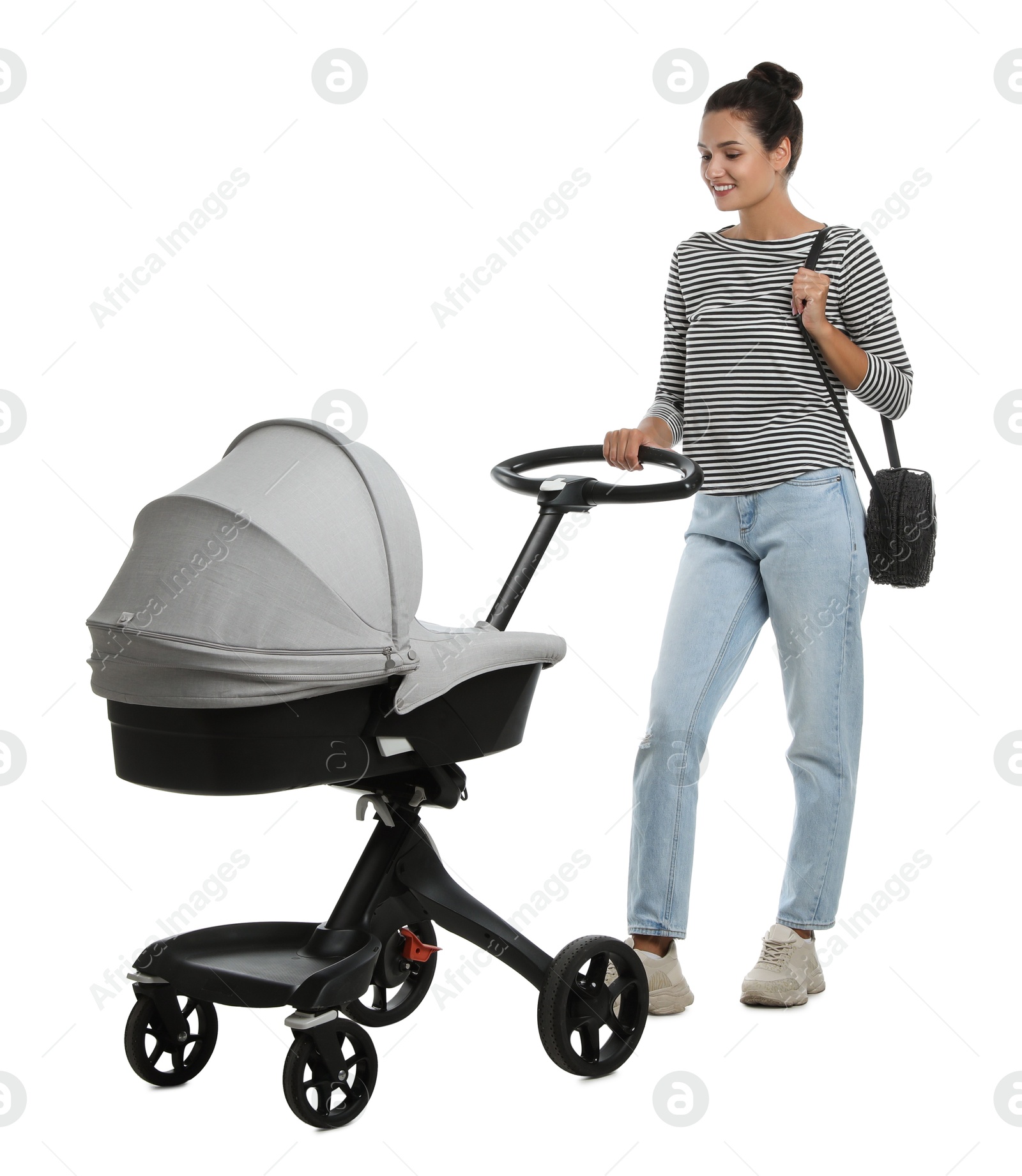 Photo of Happy young woman with baby stroller on white background