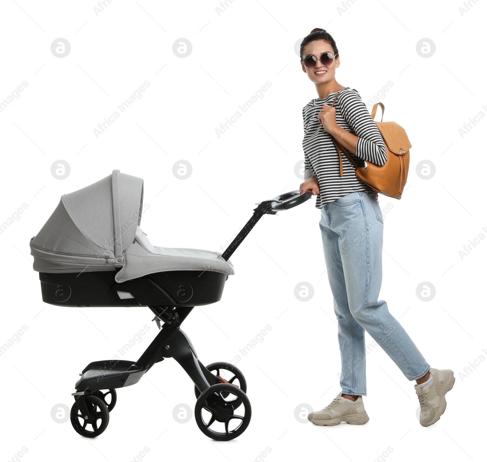 Photo of Happy young woman with baby stroller on white background