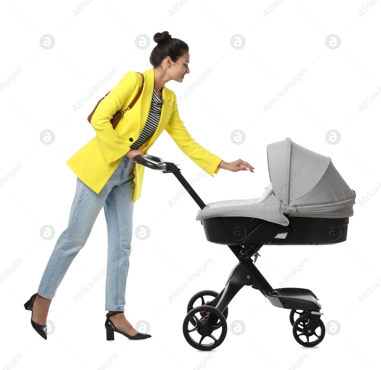 Photo of Happy young woman with baby stroller on white background