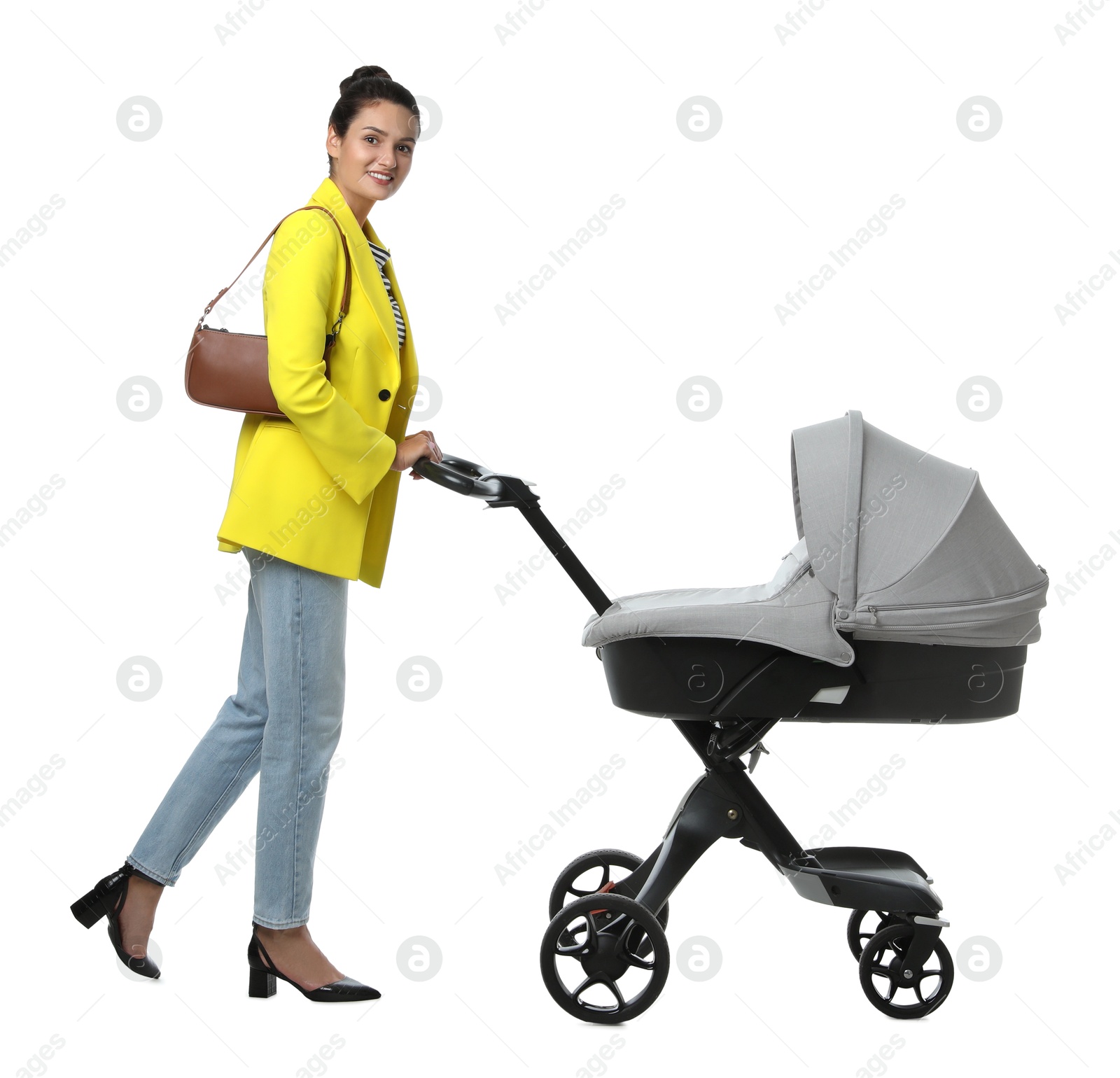 Photo of Happy young woman with baby stroller on white background