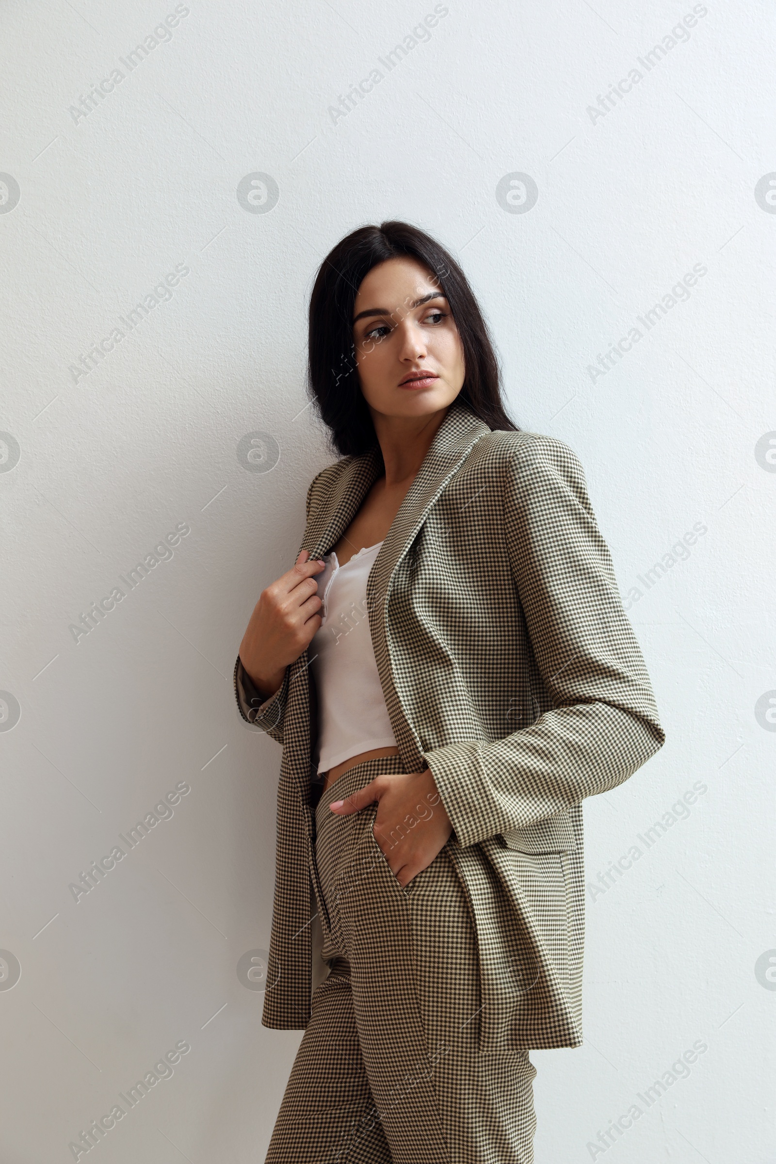 Photo of Beautiful woman in formal suit on light background. Business attire