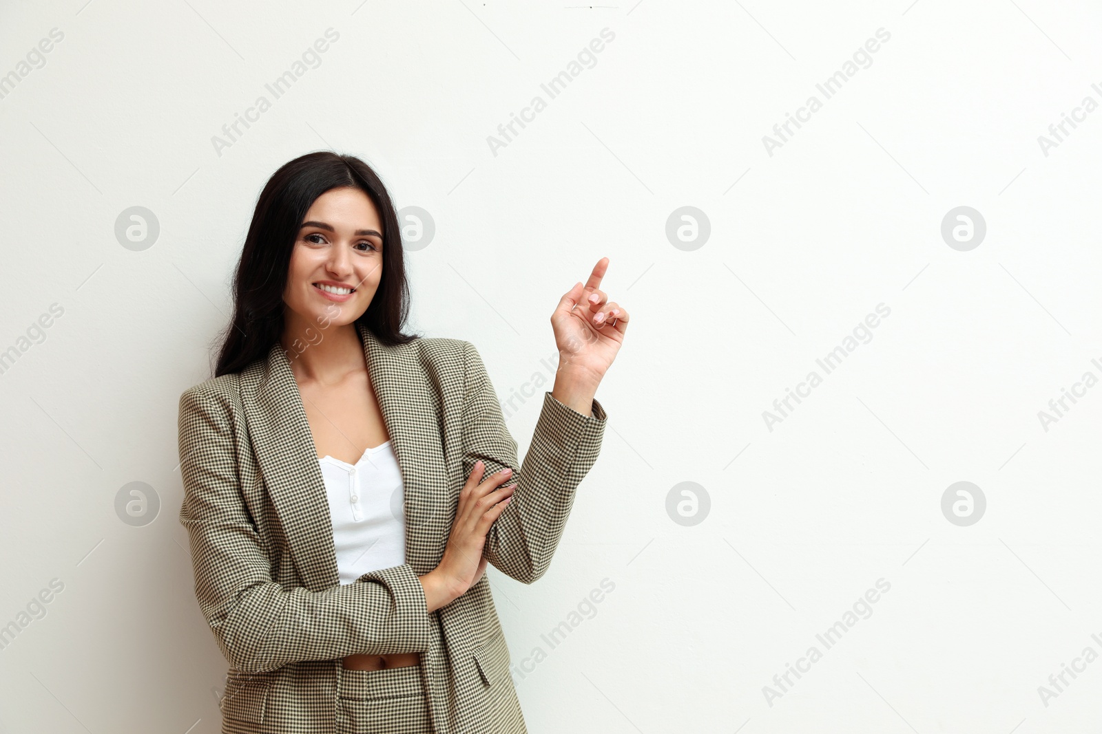 Photo of Beautiful woman in formal suit on light background, space for text. Business attire
