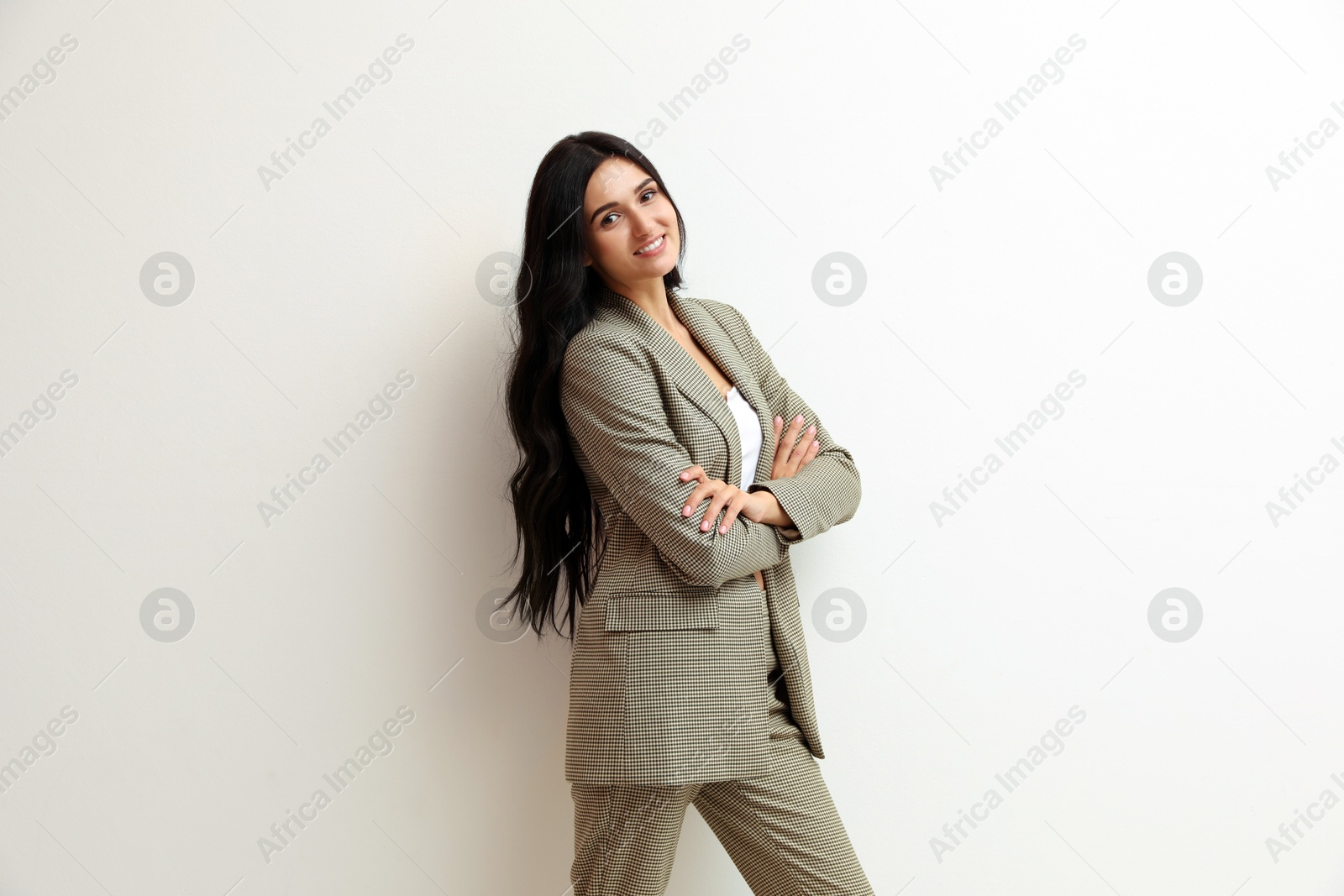 Photo of Beautiful woman in formal suit on light background. Business attire