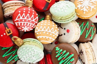 Photo of Beautifully decorated Christmas macarons as background, top view