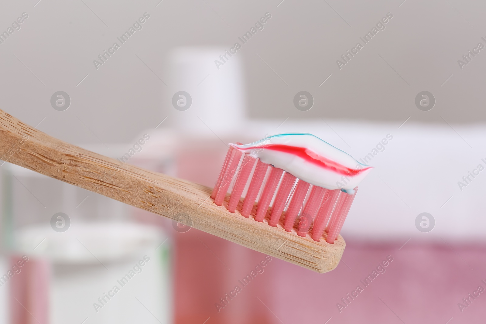 Photo of Toothbrush with paste near mouthwash on blurred background, closeup